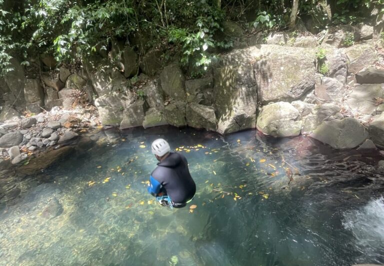 Canyoniste nageant dans une vasque d'eau claire, canyoning en Guadeloupe